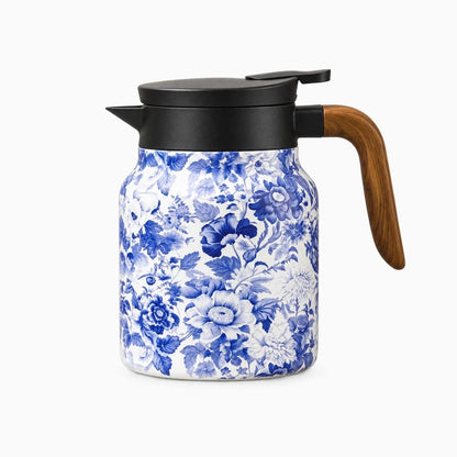 Théière thermos filtrante décorée d'un motif floral bleu sur corps métallique brillant